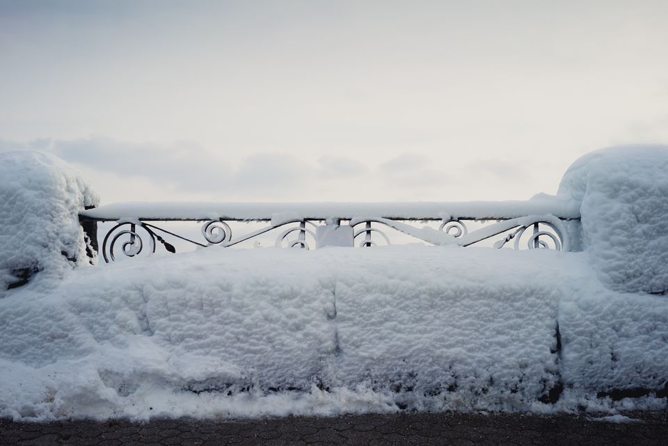 Image of a snow covered railing at sunset
